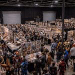 Comic book convention with vendor booths and attendees inside AKS event venue. Event venue setup at AKS Stages in Burbank