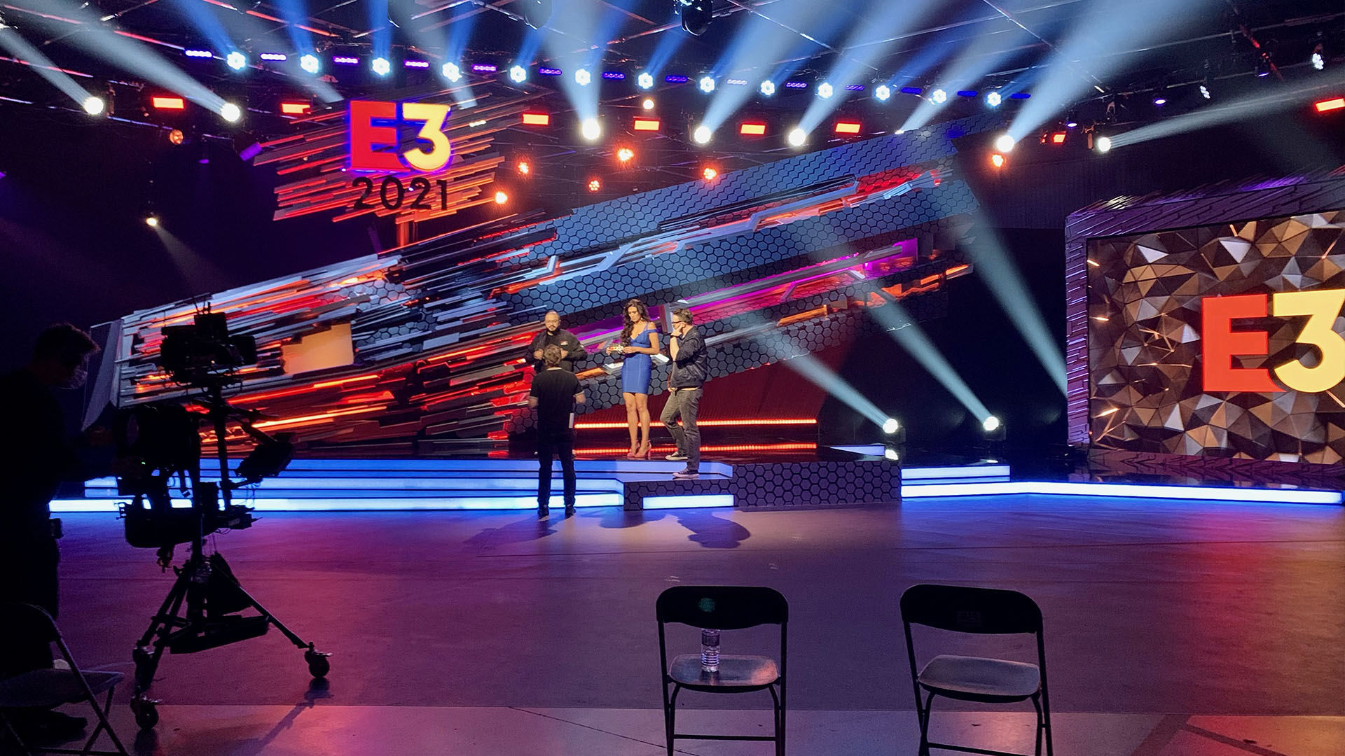 Live stage production with presenters and camera setup inside AKS event venue