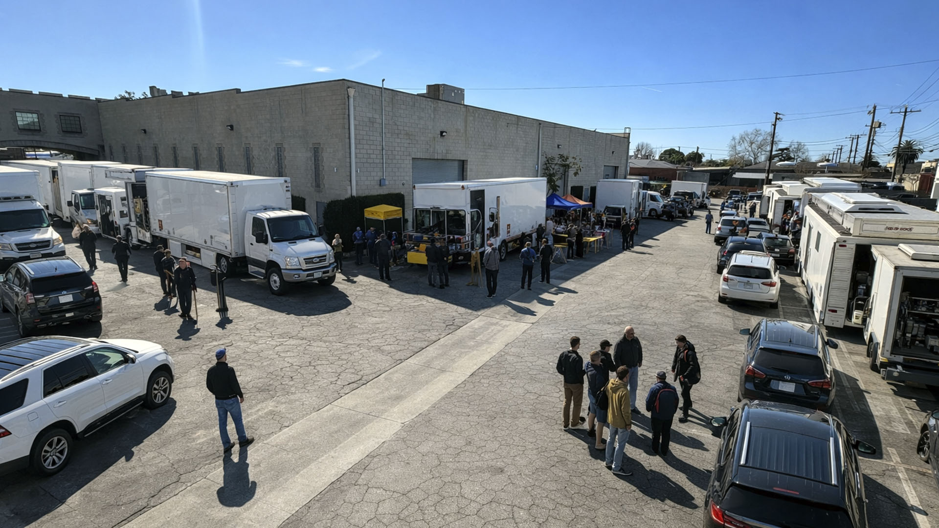 Exterior view of production trucks and crew parked at AKS Stages