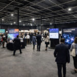 Event space rental cost: Trade show floor with exhibitor booths inside AKS Event Center